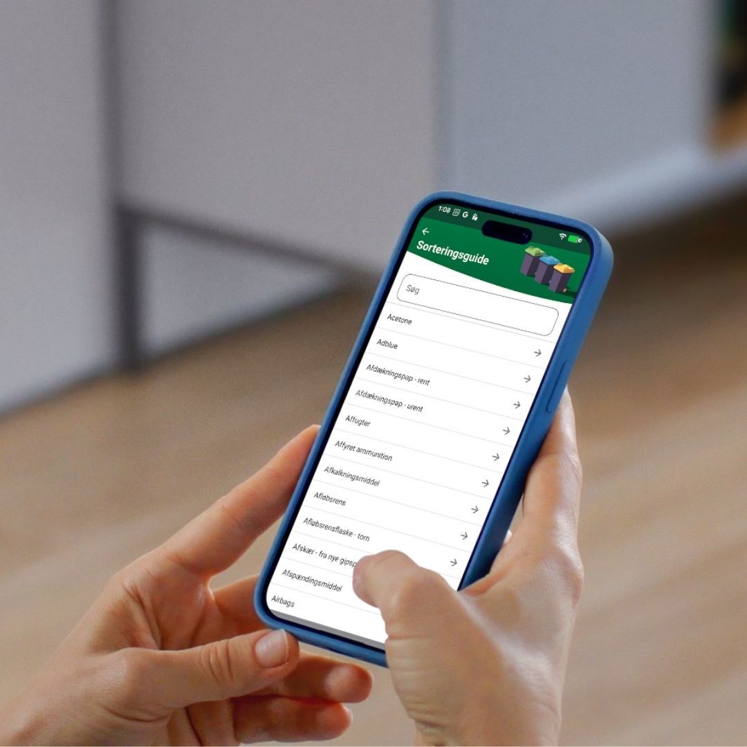 Teleson med affaldssorteringsguide på skærmen